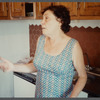 Older woman in sleeveless dress gesturing