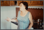 Older woman in sleeveless dress gesturing