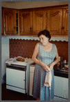 Older woman in sleeveless dress holding towel