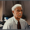 Older man with mustache being filmed