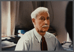 Older man with mustache being filmed