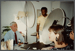 Older man with mustache being filmed