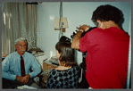 Older man with mustache being filmed