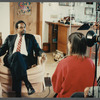 Man in suit and striped tie being filmed