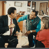 Man in suit and striped tie being filmed