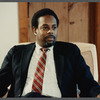 Man in suit and striped tie being filmed