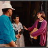 Film crew talking to woman in doorway in Paris