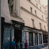 Film crew talking to woman in doorway in Paris