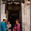 Film crew talking to woman in doorway in Paris