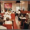 Two girls and woman in white singing at Central Holiness Church of God