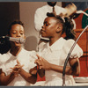 Two girls in white singing at Central Holiness Church of God