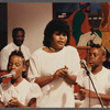 Two girls and woman in white singing at Central Holiness Church of God