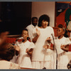 Two girls and woman in white singing at Central Holiness Church of God