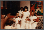 Two girls and woman in white singing at Central Holiness Church of God