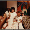 Two girls and woman in white singing at Central Holiness Church of God