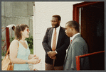 Karen Thorsen talking to two men in suits