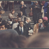 David Baldwin standing amid crowd at James Baldwin's funeral