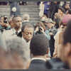 David Baldwin standing amid crowd at James Baldwin's funeral