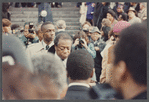 David Baldwin standing amid crowd at James Baldwin's funeral