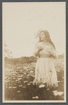 Postcard of Fania Marinoff as Wendla in an open field of flowers, related to the stage production The Awakening of Spring
