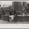 Man reading newspaper in Fountain Square, Cincinnati, Ohio.