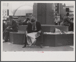 Man reading newspaper in Fountain Square, Cincinnati, Ohio.