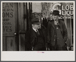 Men talking in front of saloon on lower Douglas Street, Omaha, Nebraska.