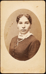 Studio portrait of young woman wearing chain necklace.