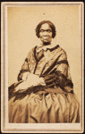 Three-quarter length portrait of unidentified woman dressed with long-fringed shawl. Born Feb. 22, 1791-72, on verso.