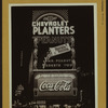 Advertisements - [Advertising signs and billboards - Advertising Chevrolet, Planters peanuts, Coca-Cola.]
