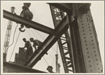 Construction workers and crane seen from below