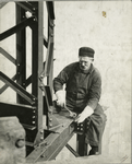 Worker attaching a bolt onto a beam
