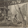 Workers guiding hoisting cable