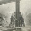Two workers securing a rivet