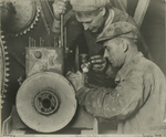Two workers repairing machinery