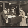 Interpreter and recorder interviewing newcomers, Ellis Island, New York