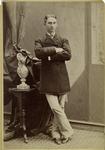 Man wearing a coat and standing with arms crossed, United States, 1870s