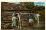 Elderly people by a well outside a cabin, 1909