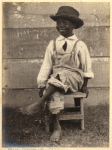 Boy seated on wooden stool