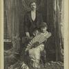 Seated woman and standing man indoors, England, 1880s