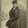 Portrait of a woman with overcoat, hat, and muff, United States, 1890s