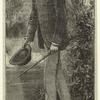 Man walking outdoors in a jacket with hat and stick, United States, 1890s