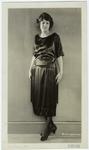 Woman in black dress with tassels, ca. 1921