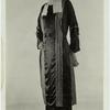 Woman in dark long-sleeved dress with vertical accents, ca. 1921