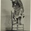 Woman standing on chair to avoid mouse