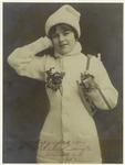 Young woman with a knitted sweater, knitted hat, and ice skates