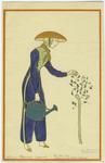 Woman wearing trousers holding a watering can and examining flowers