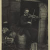 Violin player posed on barrel at the entrance to a shack