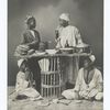 Four men and a table of food.