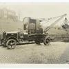 Motor-driven crane mounted on a truck chassis.